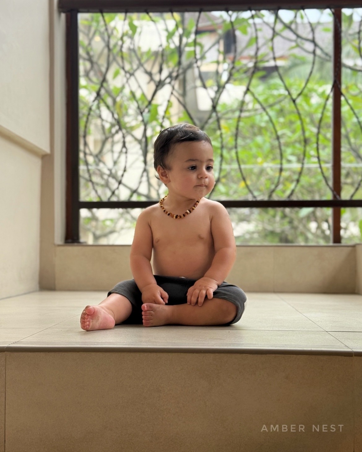 Amber Nest necklace worn by a child